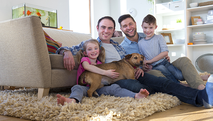 family smiling in a clean room