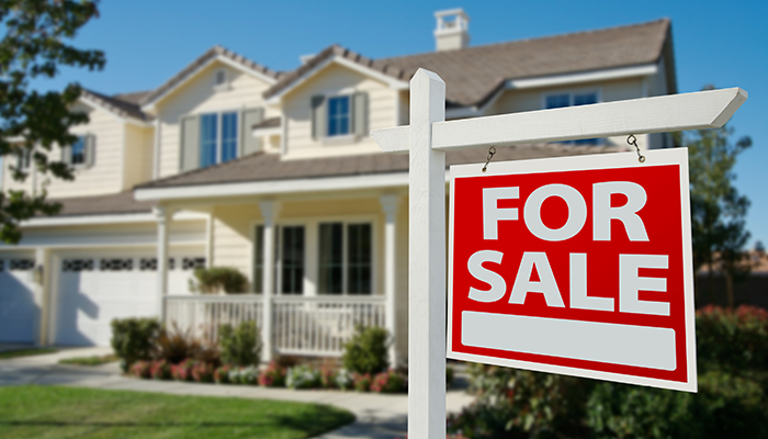 Home For Sale Real Estate Sign in Front of New House.